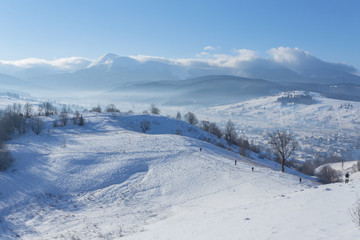 Fantastic winter landscape and trodden tourist path leading into the mountains. On the eve of the holiday.