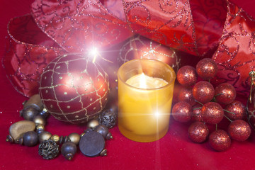 New Year's composition on a red background - ball and ribbon and a candle