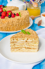 Homemade honey cake with sour cream and berries on top