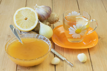 The root of ginger and honey on wooden table.