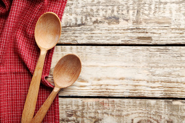 Red napkin and spoon on a grey wooden table