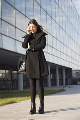 Young woman phoning with a mobile phone