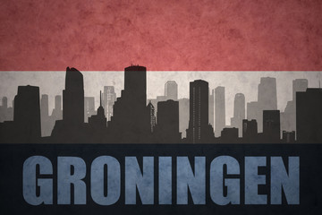 abstract silhouette of the city with text Groningen at the vintage dutch flag