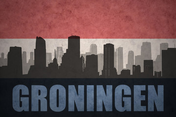 Fototapeta premium abstract silhouette of the city with text Groningen at the vintage dutch flag