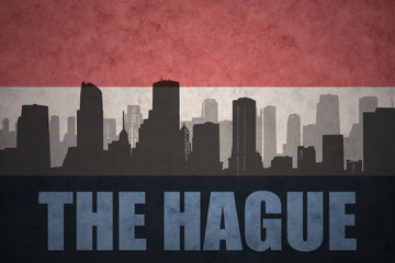 abstract silhouette of the city with text The Hague at the vintage dutch flag
