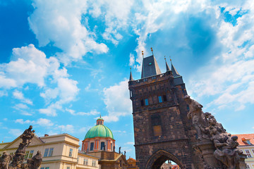 Fototapeta premium Colorful image of Old Town Bridge Tower in Prague and Charles Bridge, Czech Republic. View from the water