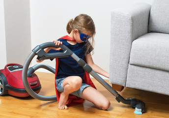 Super hero kid with vacuum cleaner.