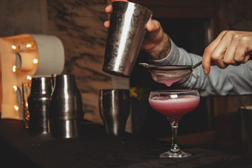 Fototapeta na wymiar Bartender making a cocktail