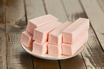 Delicious  strawberry paste  on plate on wooden