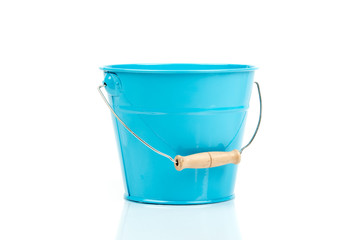 Blue iron/metal bucket/pail/container with handle isolated on white background. Colorful kid child toys. Garden equipment. Side view.