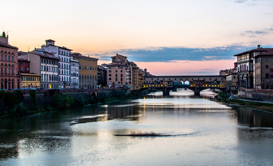 Rowinh on the Arno River by the Ponte Vecchio bridge, Florence