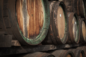 wooden barrels in the distillery folded in the yard in shelves