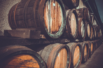 wooden barrels in the distillery folded in the yard in shelves