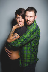 Beautiful couple hugging and laughing on the tein background. The concept of fun, love and happiness