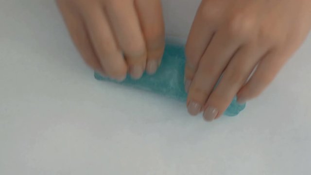 Hands playing toy called slime