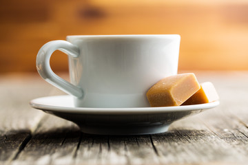 Coffee cup and caramel candies.