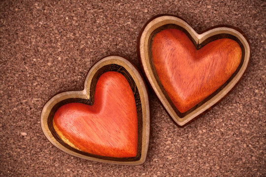 Two wooden hearts on rustic wood background. Valentines days con