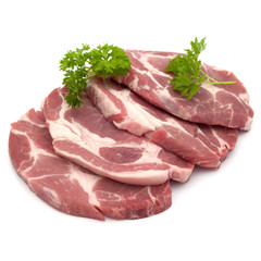 Raw pork neck chop meat with parsley herb leaves garnish isolate