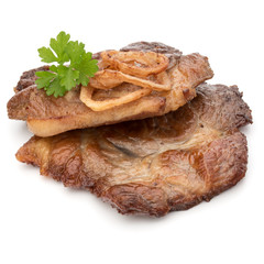 Cooked fried pork meat with parsley herb leaves and onion slices
