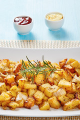 Baked potatoes on square white dish