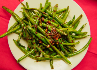 Fresh Organic Cooked Green Beans in a bowl on the red nupkin