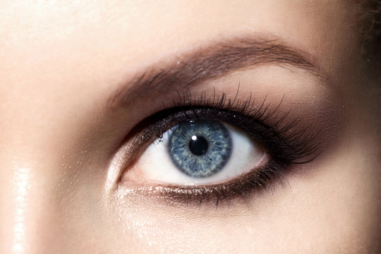 Close-up of  make up smoky eyes for blue eyes with, long eyelashes and brown eyebrows