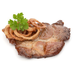 Cooked fried pork meat with parsley herb leaves and onion slices