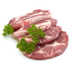 Raw pork neck chop meat with parsley herb leaves garnish isolate