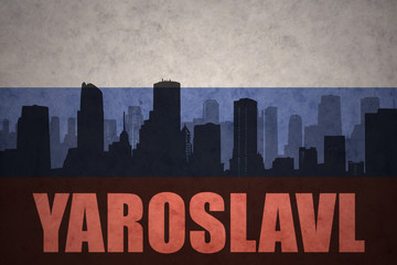 abstract silhouette of the city with text Yaroslavl at the vintage russian flag