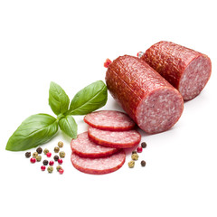 Salami smoked sausage, basil leaves and peppercorns isolated on