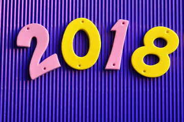 2018 in pink and yellow numbers 