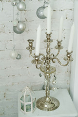 Christmas decorations with white candlestick in white living room