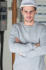 young professional electrician at work in building