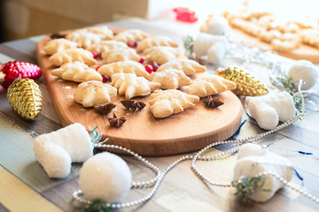 Christmas cookies among Christmas-tree decorations, toys, spices