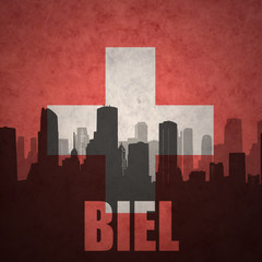 abstract silhouette of the city with text Biel at the vintage swiss flag