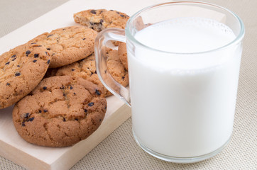 Cup with milk and oatmeal cookies