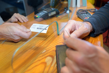 Closeup of ticket being passed through hatch