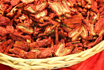 basket of dried tomatoes in the local market in Italy