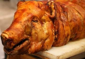 big roast pork with the big nose in the rotisserie