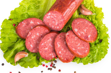 Salami with lettuce, pepper and garlic on a white background