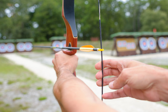 Closeup Of Bow And Arrow Being Aimed At Target