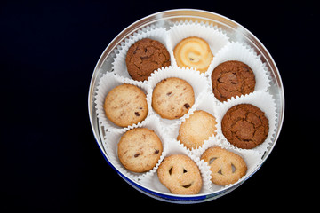 Cookies in isolated on a dark black background / sweet cookies in a box / Cookies in box.