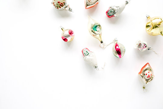 creative arrangement of bright christmas balls and toys on white background. flat lay, top view
