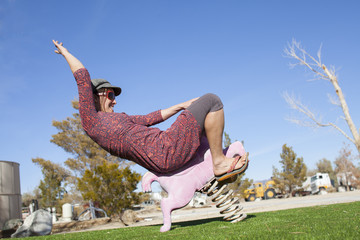 An adult woman playing cowgirl with a stylish playground performance near Lone Pine, California.