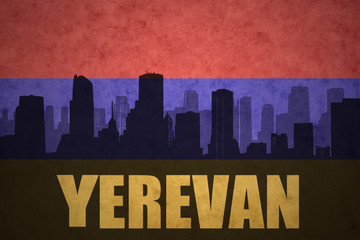 abstract silhouette of the city with text Yerevan at the vintage armenian flag