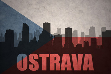 abstract silhouette of the city with text Ostrava at the vintage czech republic flag
