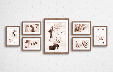 Frames collage with spring blossom motif floral posters, on bricks textured wall
