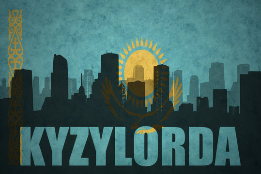 abstract silhouette of the city with text Kyzylorda at the vintage kazakhstan flag