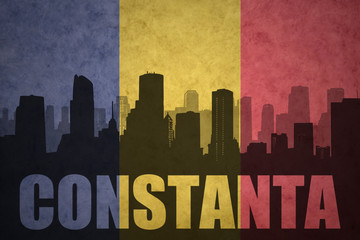 abstract silhouette of the city with text Constanta at the vintage romanian flag