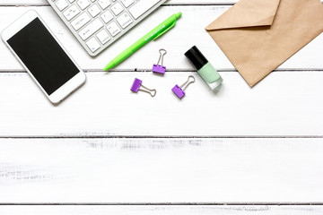 female wooden desktop with smartphone, paper envelopes top view